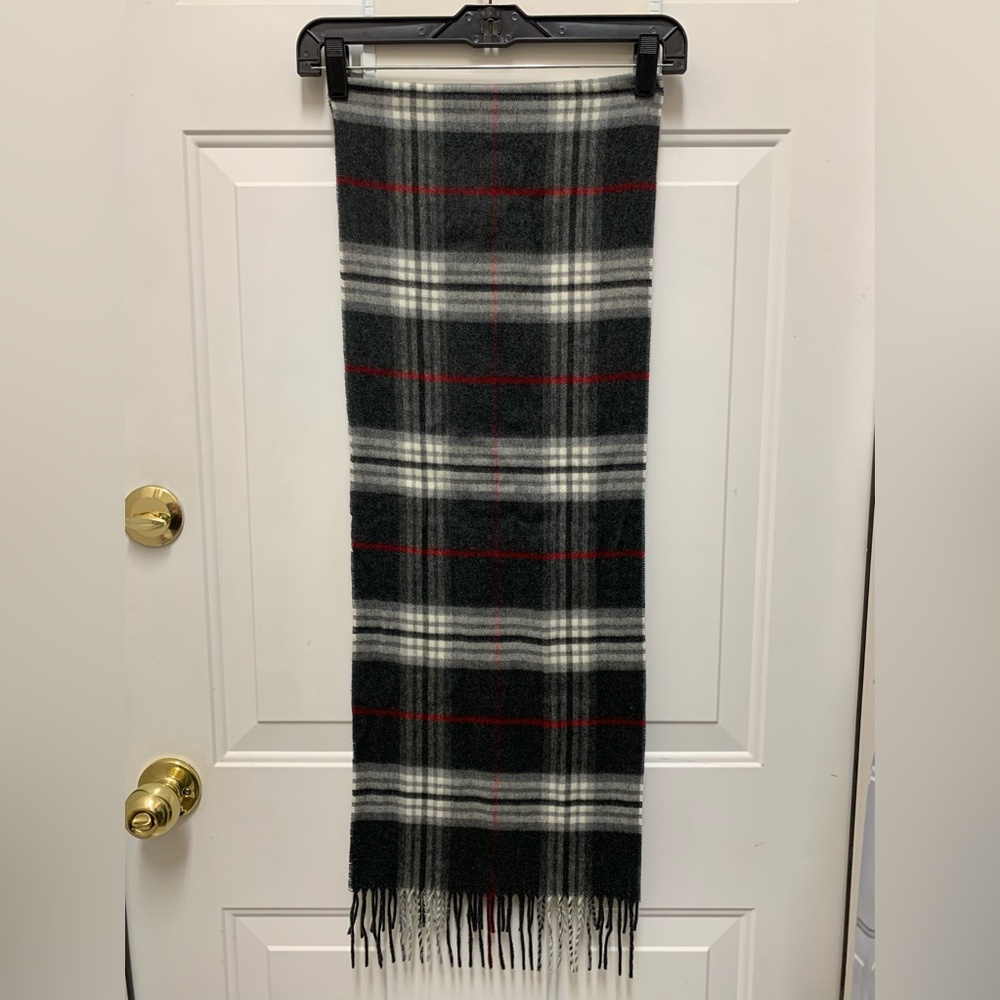Gray check print scarf tipped with fringe.